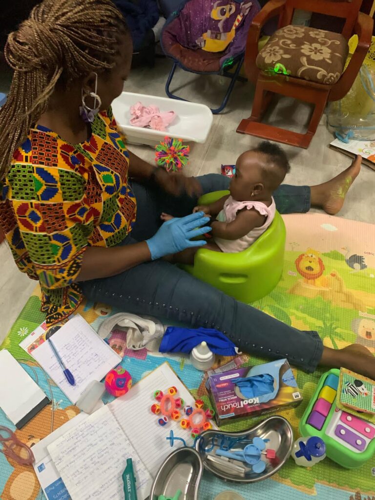 A therapist administering early intervention therapy to a student.